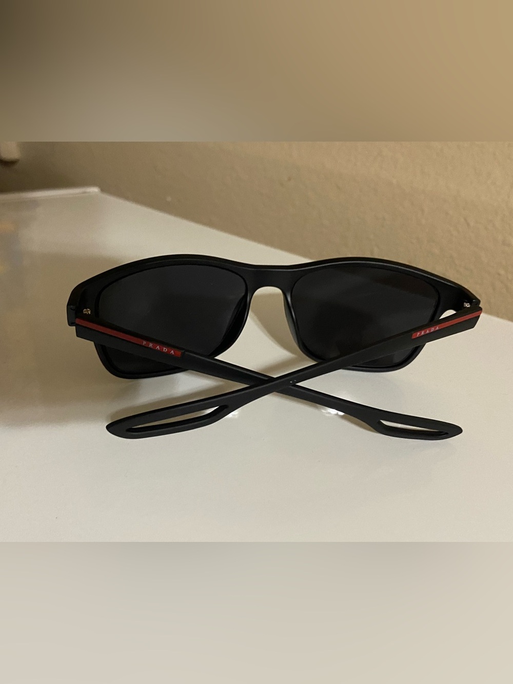 Prada Men’s Matte Black Sunglasses with Red Temple Detail